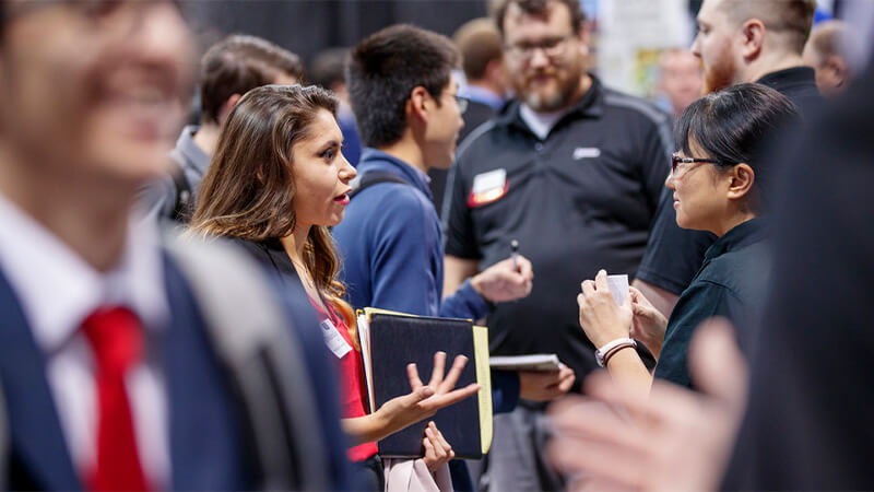 Students mingling with prospective employers.