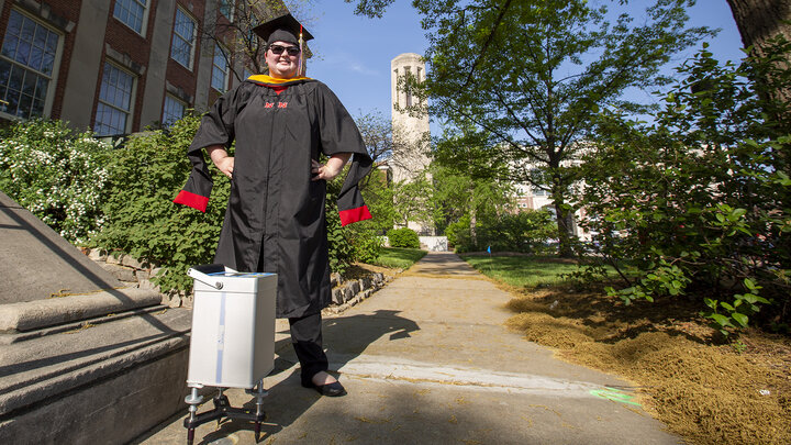 Kris Guthrie stands next to a gravimeter positioned at the gravity base station she established outside of Morrill Hall. The station — and another located by Mueller Tower — are the first on campus. They were established through part of Guthrie's graduate program in earth and atmospheric sciences.