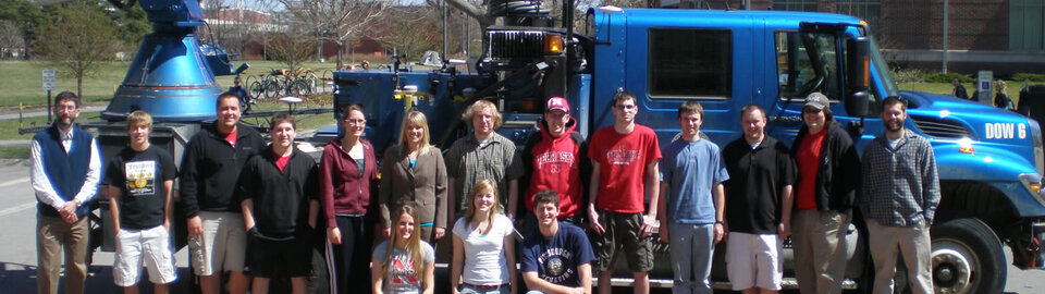 People next to research equipment